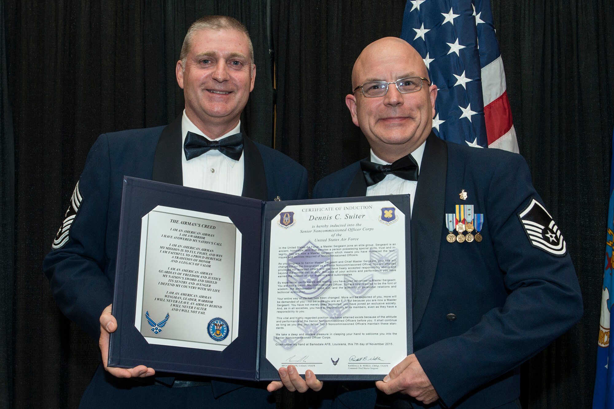 U.S. Air Force Master Sgt. Dennis Suiter is presented the Certificate of Induction during a ceremony on Nov. 7, 2015, Shreveport, La. The 307th Bomb Wing Senior Noncommissioned Officer Induction Ceremony is an annual event held to recognize Airmen who were recently promoted to the rank of Master Sergeant. (U.S. Air Force photo by Master Sgt. Greg Steele/Released)