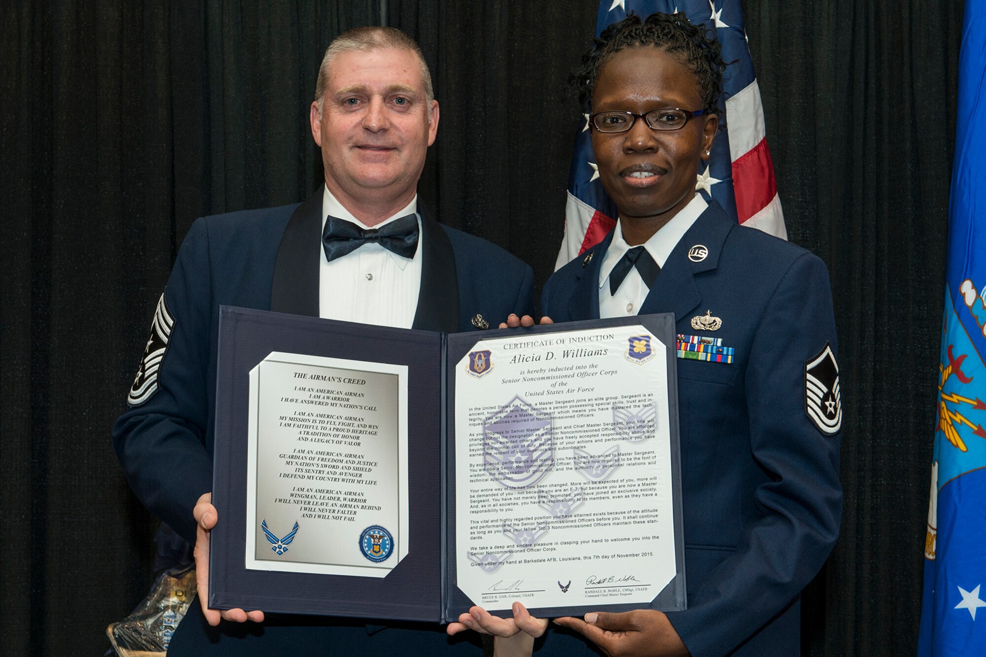 U.S. Air Force Master Sgt. Alicia Williams is presented the Certificate of Induction during a ceremony on Nov. 7, 2015, Shreveport, La. The 307th Bomb Wing Senior Noncommissioned Officer Induction Ceremony is an annual event held to recognize Airmen who were recently promoted to the rank of Master Sergeant. (U.S. Air Force photo by Master Sgt. Greg Steele/Released)