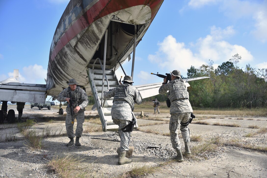 Air Force Tech. Sgt. James Heathcock, Staff Sgt. Josiah Crowell and Airman 1st Class Avery Putnam secure the exterior of the aircraft during anti-hijacking training as part of Southern Strike 16 at the Combat Readiness Training Center in Gulfport, Miss., Nov. 5, 2015. Heathcock, Crowell and Putnam are assigned to the New York Air National Guard’s 186th Security Forces Squadron. New York Air National Guard photo by Staff Sgt. Christopher S. Muncy