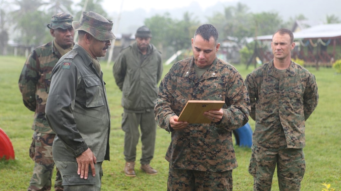 Lt. Col. Demetrius Bolduc, commanding officer for KOA MOANA 15-3, presents an award to Maj. Henry Macomber, a commander with the Republic of Fiji Military Force during a ceremony following a training exercise between the two nations in Namosi Province, Fiji, Oct. 15. Marines and members of the RFMF conducted jungle training, jungle survival exercises and participated in community rebuilding projects. 


