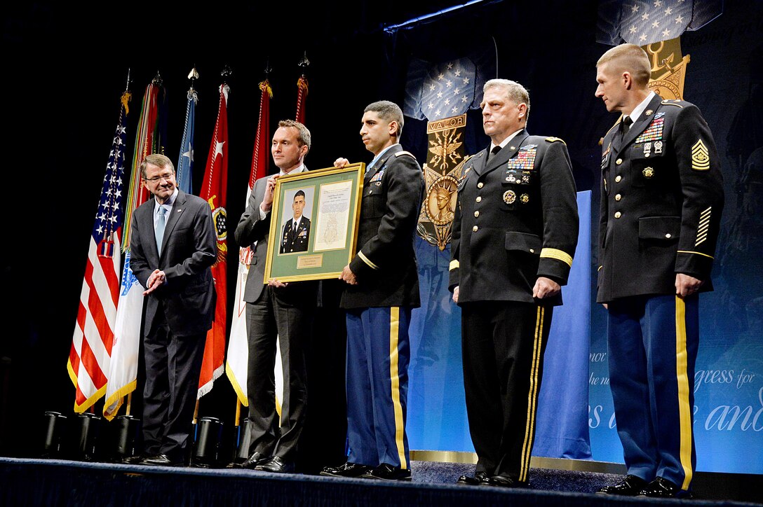 Defense Secretary Ash Carter, far left, looks on as retired Army Capt. Florent Groberg, center, a Medal of Honor recipient, accepts a plaque during the ceremony to induct him into the Hall of Heroes at the Pentagon, Nov. 13, 2015. Acting Undersecretary of the Army Eric Kenneth Fanning, second from left, Army Chief of Staff Gen. Mark A. Milley, second from right, and Sgt. Maj. of the Army Daniel A. Dailey participated in the ceremony. DoD photo by U.S. Army Sgt. 1st Class Clydell Kinchen
