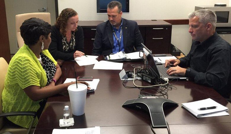 Melody Hinkle, second from left, reviews a contracting documents with procurement analysts LaVette Buford, Denver Heath and Doug Gosselin during her career broadening assignment with the Principal Assistant Responsible for Contracting-Dallas. Hinkle, a procurement analyst with the U.S. Army Engineering and Support Center, Huntsville, spent four-months working at the PARC – Dallas office which manages and administers contracts coming from the U.S. Army Corps of Engineers’ Northwest, Southwest, South Pacific and Pacific Ocean Divisions. 