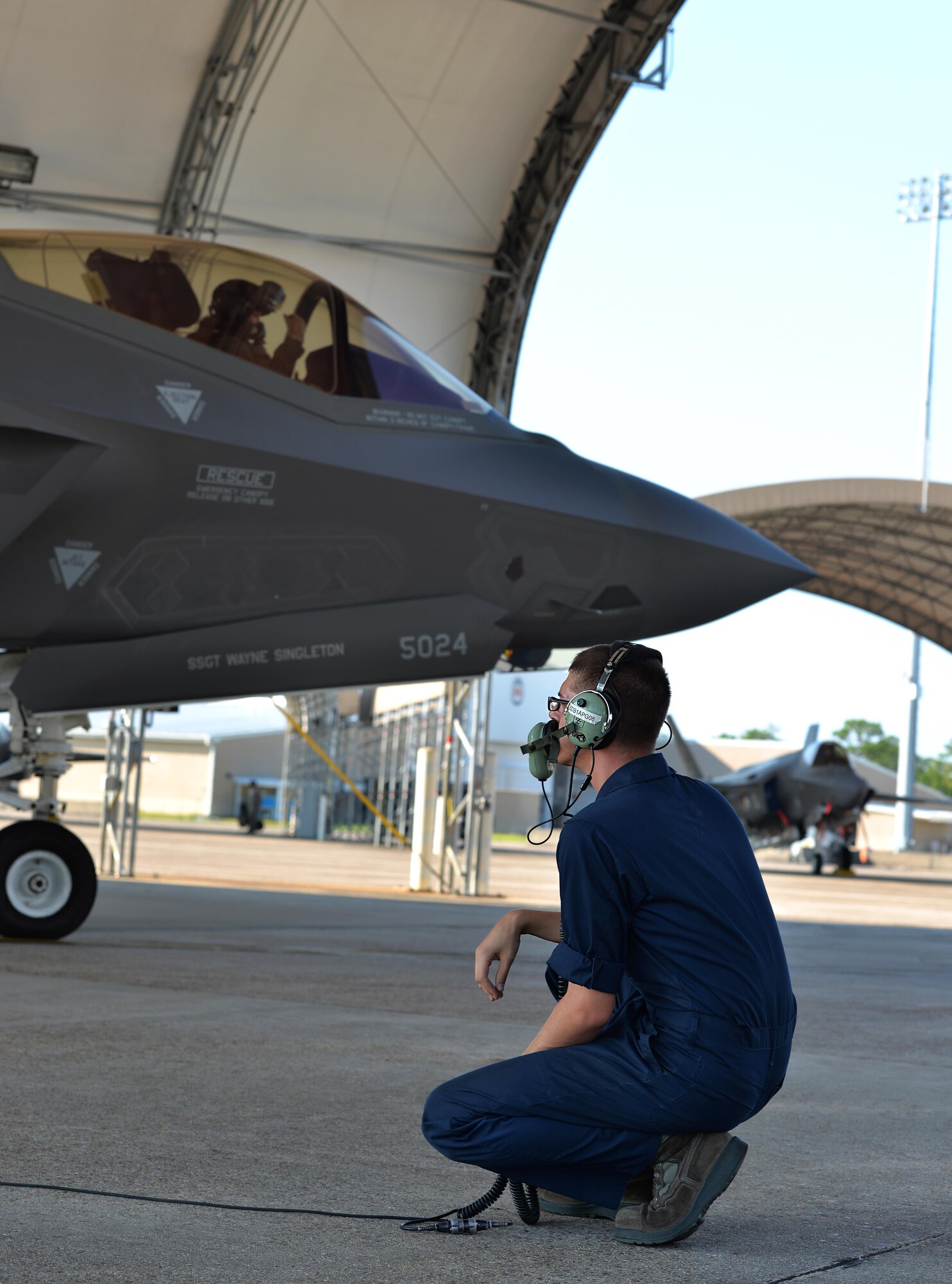 Airmen 1st Class Keenan Cormican, 33rd Aircraft Maintenance Squadron crew chief, speaks with a pilot before take-off at Eglin Air Force Base, Fla., Aug. 14, 2015. Crew chiefs work with pilots before launch to insure the aircraft is ready for take-off. (U.S. Air Force Photo/Senior Airman Andrea Posey) 