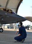 Airmen 1st Class Keenan Cormican, 33rd Aircraft Maintenance Squadron crew chief, speaks with a pilot before take-off at Eglin Air Force Base, Fla., Aug. 14, 2015. Crew chiefs work with pilots before launch to insure the aircraft is ready for take-off. (U.S. Air Force Photo/Senior Airman Andrea Posey) 