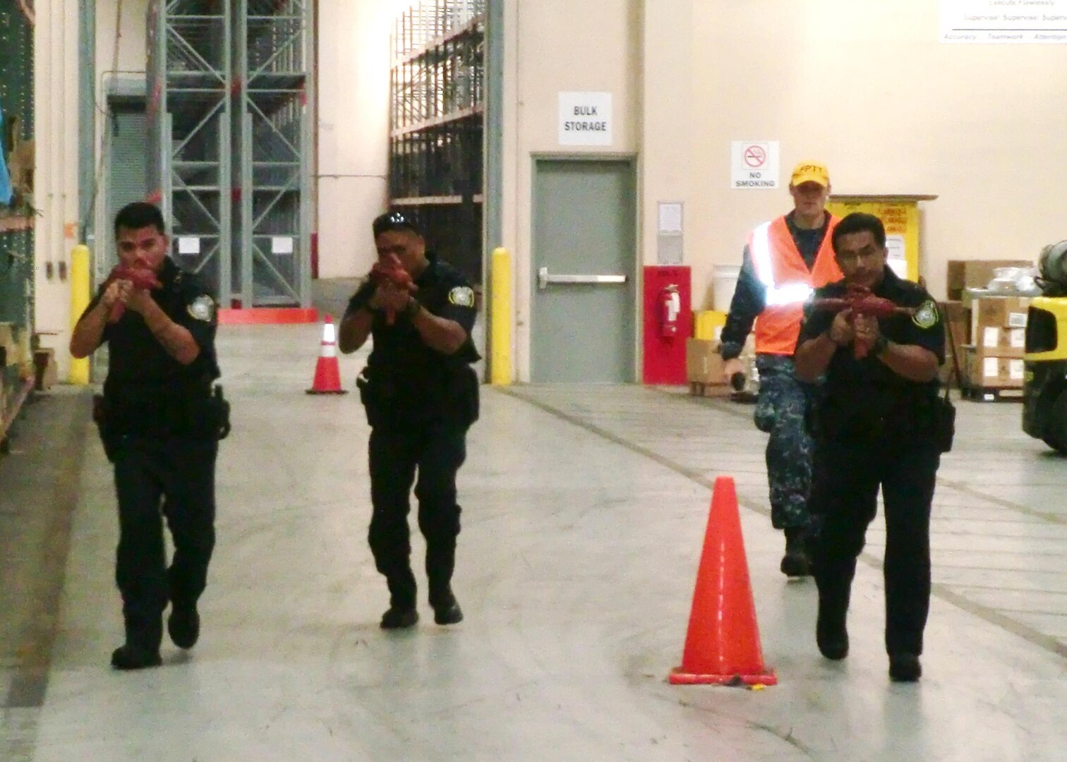 Security personnel search for an active shooter in a DLA Distribution Guam, Marianas, warehouse during an exercise on Oct. 27.