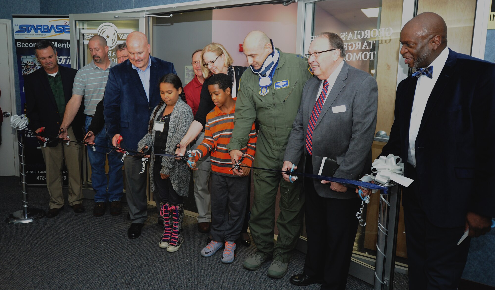 Maj. Gen. Richard Haddad, Air Force Reserve Command vice commander, Wesley Fondal, STARBASE Robins director, and others celebrate the addition of four new classrooms Nov. 6, 2015 at the Museum of Aviation, Robins Air Force Base, Georgia. The new classrooms will allow STARBASE Robins to take on additional schools, which means more students can participate in the program's hands-on educational activities. (U.S. Air Force photo by Staff Sgt. Sarah Hanson/RELEASED)