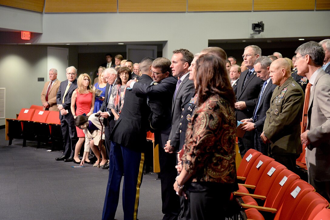 Defense Secretary Ash Carter and Medal of Honor recipient, retired Army Capt. Florent A. Groberg share an embrace during the Hall of Heroes induction ceremony at the Pentagon, Nov. 13, 2015. DoD photo by Army Sgt. 1st Class Clydell Kinchen