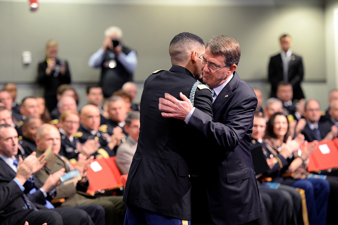 Defense Secretary Ash Carter shares an embrace with retired Army Capt. Florent A. Groberg, a Medal of Honor recipient following a speech during his Hall of Heroes induction ceremony at the Pentagon, Nov. 13, 2015. DoD photo by Army Sgt. 1st Class Clydell Kinchen    