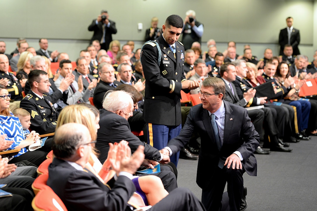 Defense Secretary Ash Carter shakes hands with Larry Groberg, the father of Medal of Honor recipient, retired Army Capt. Florent A. Groberg during his Hall of Heroes induction ceremony at the Pentagon, Nov. 13, 2015. DoD photo by Army Sgt. 1st Class Clydell Kinchen    