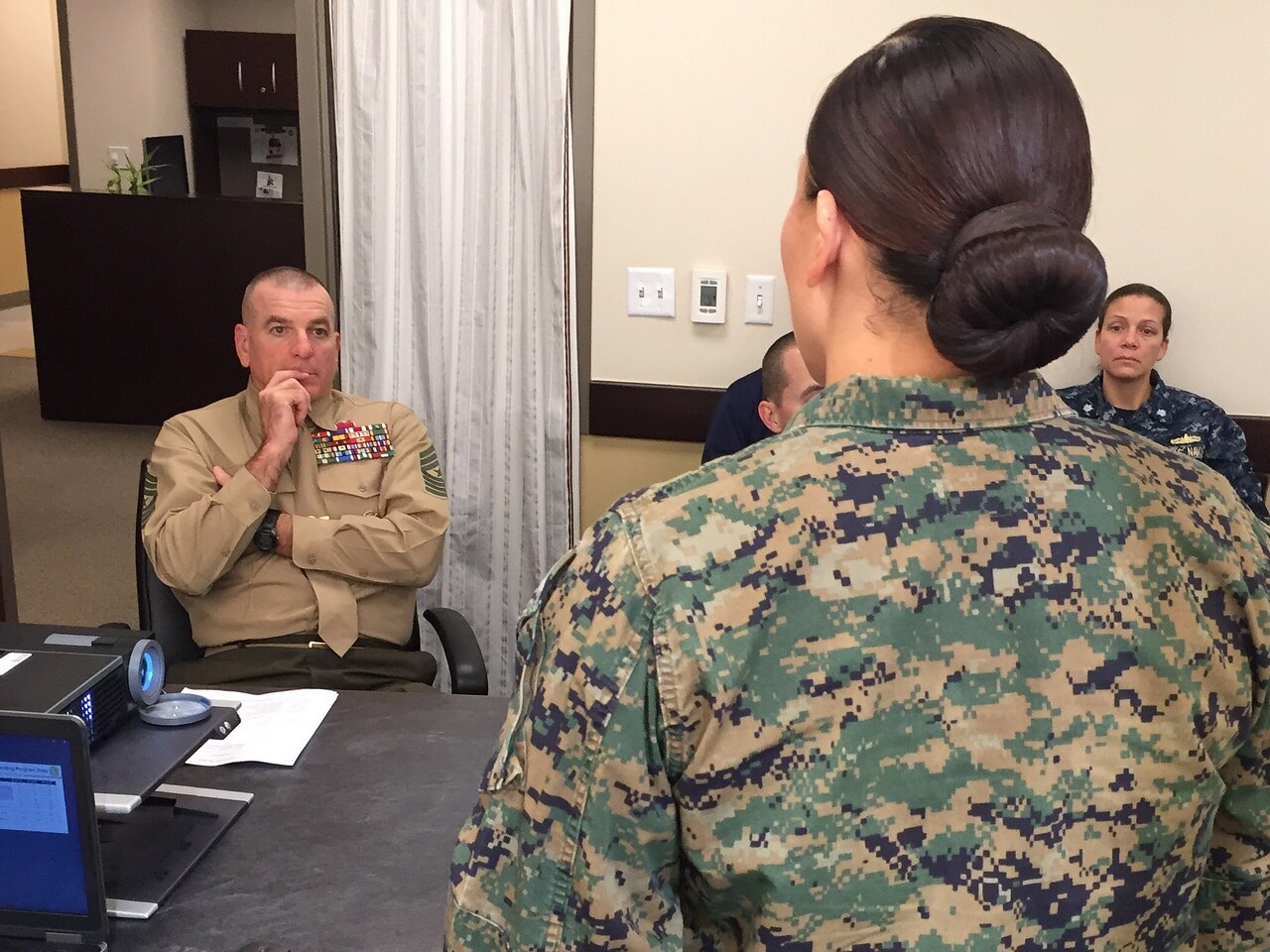 Marine Corps Sgt. Maj. Bryan B. Battaglia, the senior enlisted advisor to the chairman of the Joint Chiefs of Staff, receives a briefing from senior staff at the San Diego Military Entrance Processing Station during his Nov. 12, 2015, visit to the facility as part of his commitment to thanking the personnel who prepare future troops for entry to the military. DoD photo by Claudette Roulo