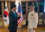 151110-N-DX698-256 HONOLULU (Nov. 10, 2015) - The Consul General of the Republic of Korea, Mr. Walter K. Paik, presents the ROK President Order of National Security Merit Samil Medal to Capt. Phil W. Yu, U.S. Pacific Command Division Chief for Northeast Asia Policy during the Third ROK-U.S. Alliance Night Reception.  Yu was recognized for his contributions to strengthening the U.S.-ROK partnership against piracy in the India Ocean, the ISIL-threat, and climate change. 