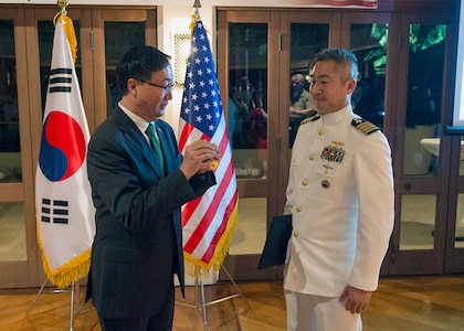 151110-N-DX698-256 HONOLULU (Nov. 10, 2015) - The Consul General of the Republic of Korea, Mr. Walter K. Paik, presents the ROK President Order of National Security Merit Samil Medal to Capt. Phil W. Yu, U.S. Pacific Command Division Chief for Northeast Asia Policy during the Third ROK-U.S. Alliance Night Reception.  Yu was recognized for his contributions to strengthening the U.S.-ROK partnership against piracy in the India Ocean, the ISIL-threat, and climate change. 