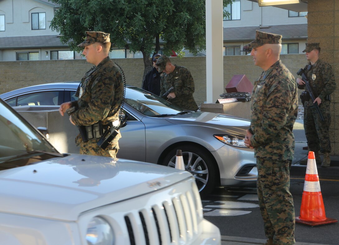 Col. Jason Woodworth, commanding officer of Marine Corps Air Station Miramar and Sgt. Maj. Richard Charron, sergeant major of MCAS Miramar, check identification cards at the North gate aboard MCAS Miramar, Calif., Nov. 13. Every service member and Department of Defense employee has a common access card they must show to gain access to the base.