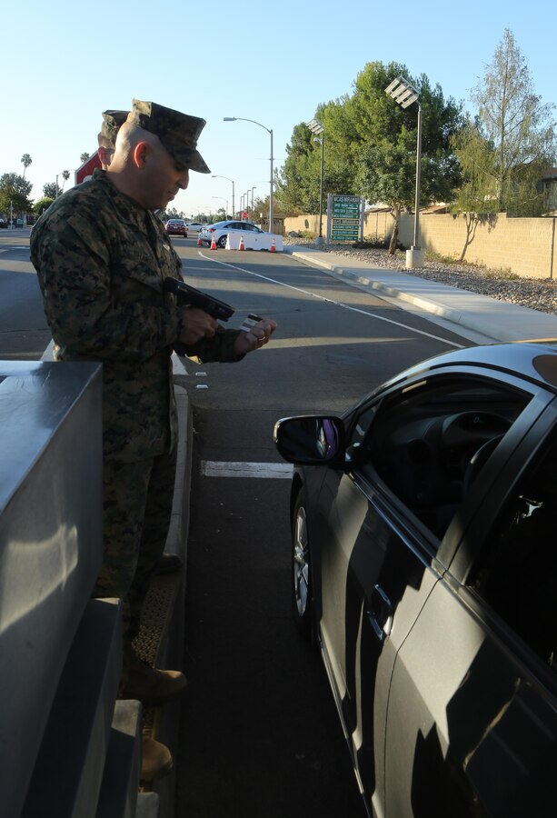 Sgt. Maj. Richard Charron, sergeant major of Marine Corps Air Station Miramar, checks identification cards at the North gate aboard MCAS Miramar, Calif., Nov. 13. Every service member and Department of Defense employee has a common access card they must show to gain access to the base.