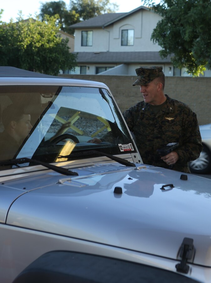 Col. Jason Woodworth, commanding officer of Marine Corps Air Station Miramar, check identification cards at the North gate aboard MCAS Miramar, Calif., Nov. 13. Every service member and Department of Defense employee has a common access card they must show to gain access to the base.