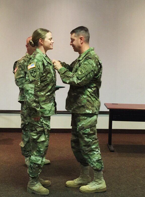 Brig. Gen. Jason Walrath, commander 100th Training Division, awards the Meritorious Service Medal to Staff Sgt. Katie Gonovi, a health care specialist instructor 100th TD, Fort Knox, Ky., Sept. 28, 2015. Govoni used her combat medic skills to help two stabbing victims in Louisville, Ky., Aug. 23, 2015.