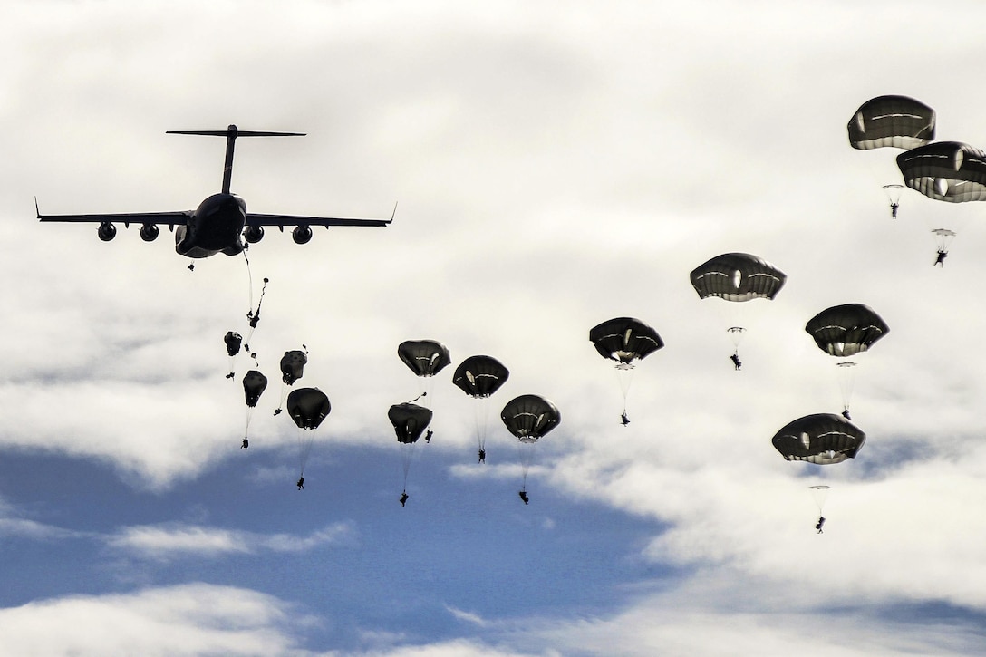 U.S. paratroopers parachute from C-17 Globemaster III aircraft for a joint forcible entry operation as part of military demonstration during Operation Trident Juncture near San Gregorio, Spain, Nov. 4, 2015. The paratroopers are assigned to the 82nd Airborne Division’s 2nd Brigade Combat Team. U.S. Army photo by Staff Sgt. Jason Hull