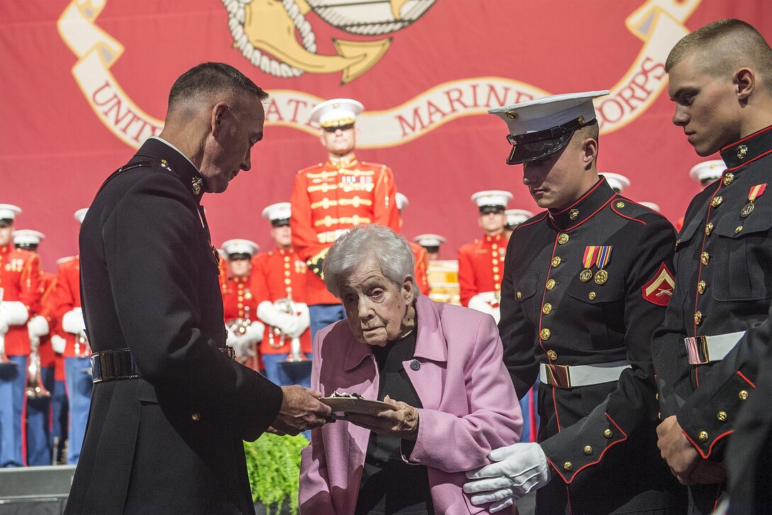 Marine Corps Gen. Joseph F. Dunford Jr., chairman of the Joint Chiefs of Staff, presents a slice of cake to the oldest Marine present while commemorating the Marine Corps' birthday at the Boston Semper Fidelis Society Birthday Luncheon in Boston, Nov. 13, 2015. DoD photo by Navy Petty Officer 2nd Class Dominique A. Pineiro