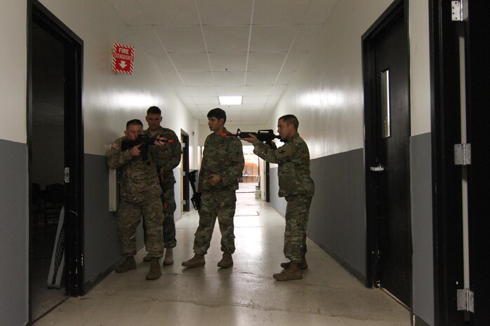 The 8th Special Troops Battalion Warrior Training Center Instructors learn new room clearing techniques from Sgt. Tom Tienda, the 8th Theater Sustainment Command commanding general’s driver and military police noncommissioned officer, November 12. The WTC features a wide variety of training conducted both in the classroom and hands-on such as Military Operations in Urban Terrain [MOUT], crew-served weapons, Modern Army Combatives Program training level one and two, military and bus driver training, combat lifesaver and field sanitation.