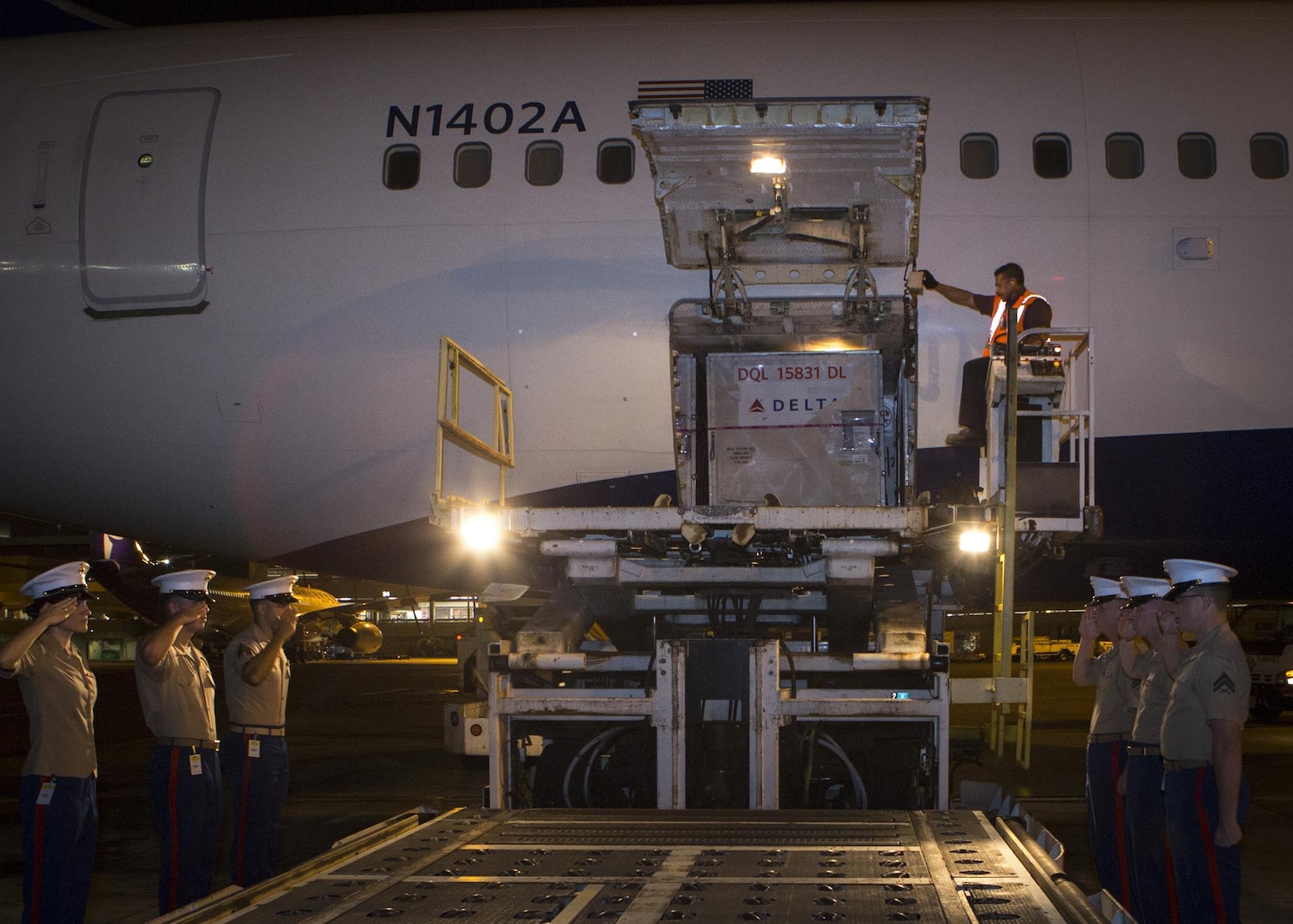 Marines with U.S. Marine Corps Forces, Pacific salute Cpl. Roger K. Nielson during a dignified transfer of remains at the Honolulu International Airport, Nov. 12, 2015. Nielson was a World War II Marine assigned to Company E, 2nd Battalion, 8th Marine Regiment, 2nd Marine Division, who was killed during the battle of Tarawa, where more than 18,000 Marines fought and more than 1,000 were killed over three days of fighting. (U.S. Marine Corps photo by Sgt. Erik Estrada)
