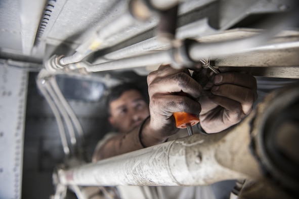 Senior Airman Jesse Anocibar, 455th Expeditionary Aircraft Maintenance Squadron crew chief, deployed from Dyess Air Force Base, Texas, removes a bolt on a C-130 Hercules at Bagram Airfield, Afghanistan, Nov. 13, 2015. The 455th EAMXS is responsible for repairing and maintaining military aircraft on Bagram, as well as performing preventative maintenance inspections. (U.S. Air Force photo/Tech. Sgt. Robert Cloys/RELEASED)