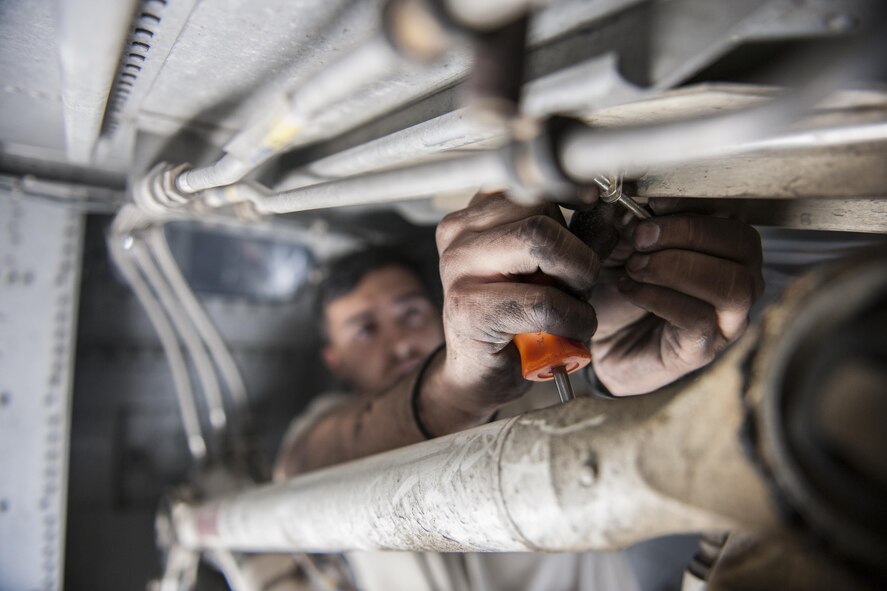 Senior Airman Jesse Anocibar, 455th Expeditionary Aircraft Maintenance Squadron crew chief, deployed from Dyess Air Force Base, Texas, removes a bolt on a C-130 Hercules at Bagram Airfield, Afghanistan, Nov. 13, 2015. The 455th EAMXS is responsible for repairing and maintaining military aircraft on Bagram, as well as performing preventative maintenance inspections. (U.S. Air Force photo/Tech. Sgt. Robert Cloys/RELEASED)