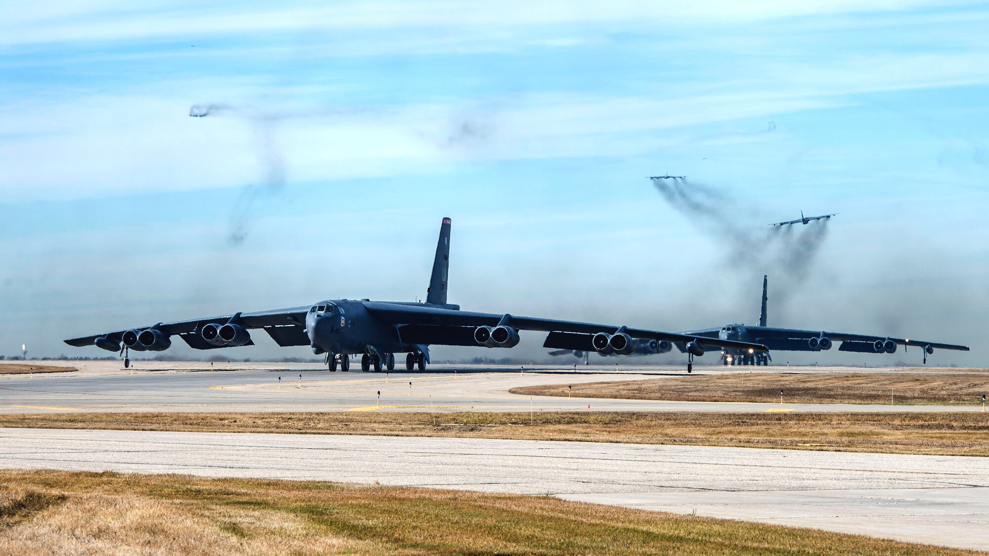 Two B-52 Stratofortress bombers assigned to Air Force Global Strike Command (AFGSC) taxi while three others take off from the flight line at Minot Air Force Base, N.D., Nov. 8, 2015, during Exercise GLOBAL THUNDER 16. AFGSC supports USSTRATCOM’s global strike and nuclear deterrence missions by providing strategic assets, including bombers like the B-52 and B-2, to ensure a safe, secure, effective and ready deterrent force. GLOBAL THUNDER is an annual U.S. Strategic Command training event that assesses command and control functionality in all USSTRATCOM mission areas and affords component commands a venue to evaluate their joint operational readiness. Planning for GLOBAL THUNDER 16 has been underway for more than a year and is based on a notional scenario with fictitious adversaries. One of nine DoD unified combatant commands, USSTRATCOM has global strategic missions, assigned through the Unified Command Plan, which also include; space operations; cyberspace operations; joint electronic warfare; missile defense; intelligence, surveillance and reconnaissance; combating weapons of mass destruction; and analysis and targeting. (U.S. Air Force photo by Airman 1st Class Justin Armstong)