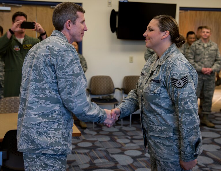 Col. Thomas Kunkel, 23d Wing commander, coins Staff Sgt. Megan Rodgers, 23d Force Support Squadron, after a tour of the facility after the Georgia Pines Dining Facility ribbon cutting ceremony, Nov. 13, 2015, at Moody Air Force Base, Ga. Georgia Pines will be serving its first meal Sunday, Nov. 15. (U.S. Air Force photo/Tech. Sgt. Zachary Wolf)