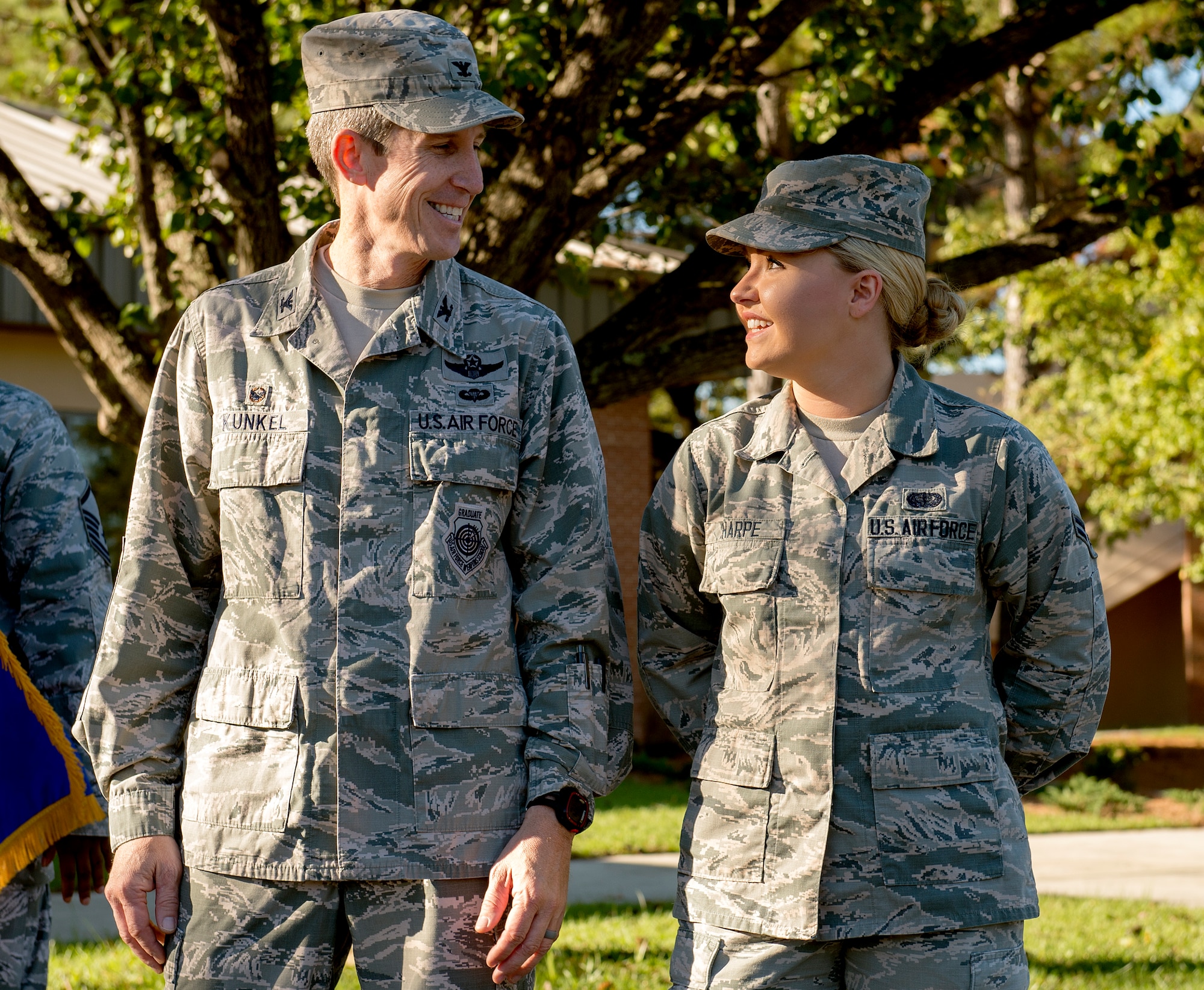 Col. Thomas Kunkel, 23d Wing commander, and Airman 1st Class Ardella Tharpe, 23d Force Support Squadron services apprentice, pause after cutting the ribbon during the Georgia Pines Dining Facility ribbon cutting ceremony, Nov. 13, 2015, at Moody Air Force Base, Ga. The dining facility will serve all active-duty enlisted members everyday and officers, retirees and families on weekends and holidays. (U.S. Air Force photo/Tech. Sgt. Zachary Wolf)