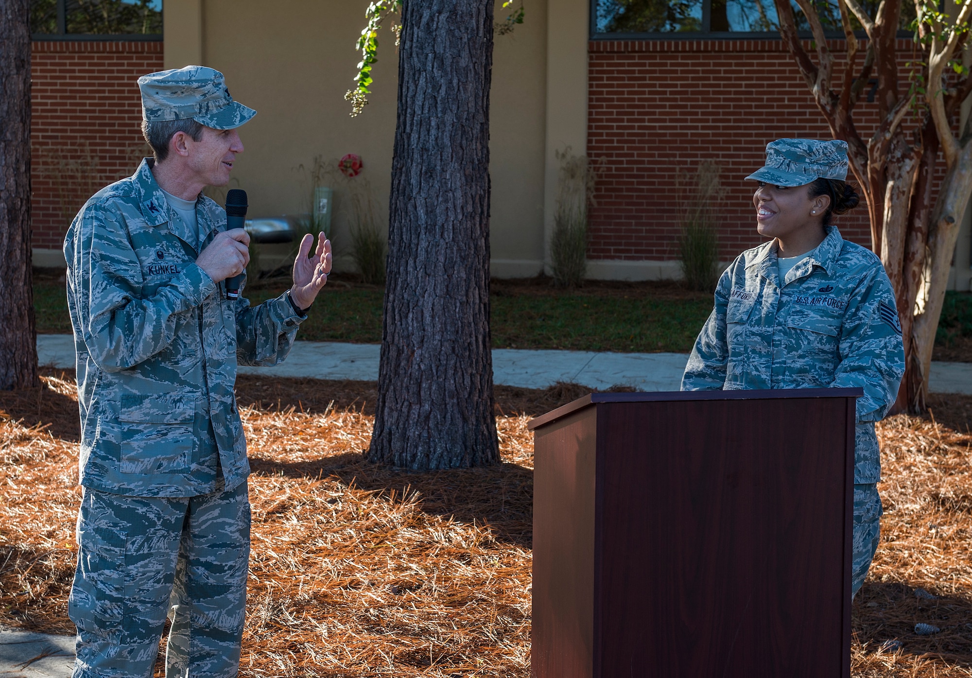 Col. Thomas Kunkel, 23d Wing commander, thanks Staff Sgt. Maria Gafford, 23d Force Support Squadron, for introducing him during the Georgia Pines Dining Facility ribbon cutting ceremony, Nov. 13, 2015, at Moody Air Force Base, Ga. Georgia Pines will be serving its first meal Sunday, Nov. 15. (U.S. Air Force photo/Tech. Sgt. Zachary Wolf)