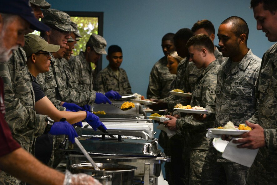 Airmen go through the buffet-style line during the Airmen’s Thanksgiving Luncheon, Nov. 13, 2015, at Moody Air Force Base, Ga. Moody Chiefs Group hosted the luncheon at the base Chapel and offered holiday favorites including turkey, mashed potatoes and gravy and pumpkin pie. (U.S. Air Force photo by Airman 1st Class Janiqua P. Robinson/Released)