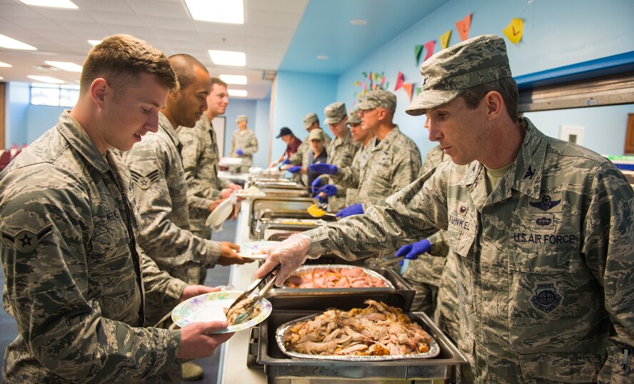 U.S. Air Force Col. Thomas Kunkel, 23d Wing commander, serves food during the Airmen’s Thanksgiving Luncheon, Nov. 13, 2015, at Moody Air Force Base, Ga. Moody Chiefs Group, with the support of various base organizations, held the luncheon because many Airmen are unable to return home for Thanksgiving. (U.S. Air Force photo by Senior Airman Ceaira Tinsley/Released)