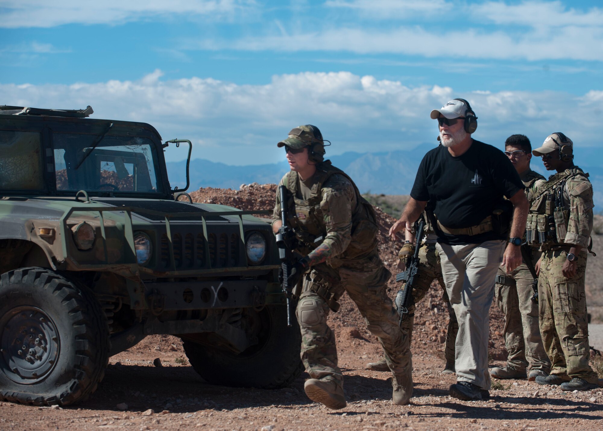 Retired Chief Master Sgt. Paul Koester, 58th Rescue Squadron chief enlisted manager, mentors an Airman participating in a training scenario Oct. 22 at Nellis Air Force Base, Nev. Koester entered the Air Force in 1974 and served a combined 41 years on active duty and Air National Guard. (U.S. Air Force photo by Airman 1st Class Jake Carter)