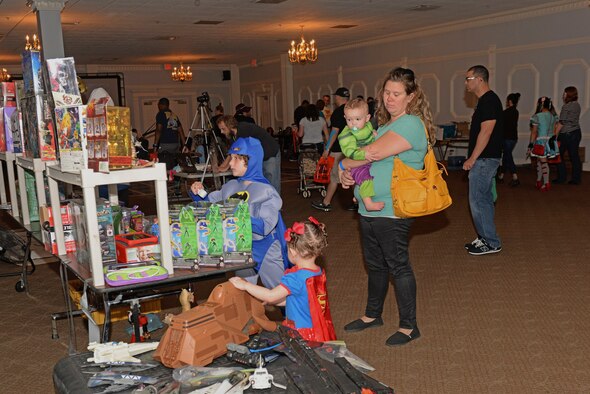 Members of Team Seymour check out tabletop displays during the inaugural Seymour Johnson Comic Expo, Nov. 7, 2015, at Seymour Johnson Air Force Base, North Carolina. Comics, actions figures, books and toys filled tables throughout the expo for attendees to view and buy. (U.S. Air Force photo/Airman 1st Class Ashley Williamson)