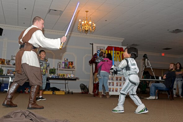 Senior Airman Michael Imparato, 4th Logistics Readiness Squadron patrol oil lubricants specialist, posing as a Jedi Knight and a ‘Stormtrooper’ face off in a live action role-playing duel during the inaugural Seymour Johnson Comic Expo, Nov. 7, 2015, at Seymour Johnson Air Force Base, North Carolina. LARPing is a form of role-playing in which participants act out their characters’ actions and personality. (U.S. Air Force photo/Airman 1st Class Ashley Williamson)