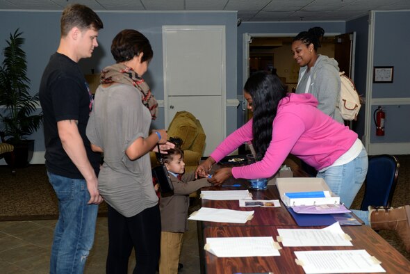 Senior Airman Sher-Kona Malcom, 4th Force Support Squadron community programming and partnership office services specialist, checks in members of Team Seymour into the inaugural Seymour Johnson Comic Expo, Nov. 7, 2015, at Seymour Johnson Air Force Base, North Carolina. The expo featured multiple events including costume contests, human chess and a video game tournament. (U.S. Air Force photo/Airman 1st Class Ashley Williamson)