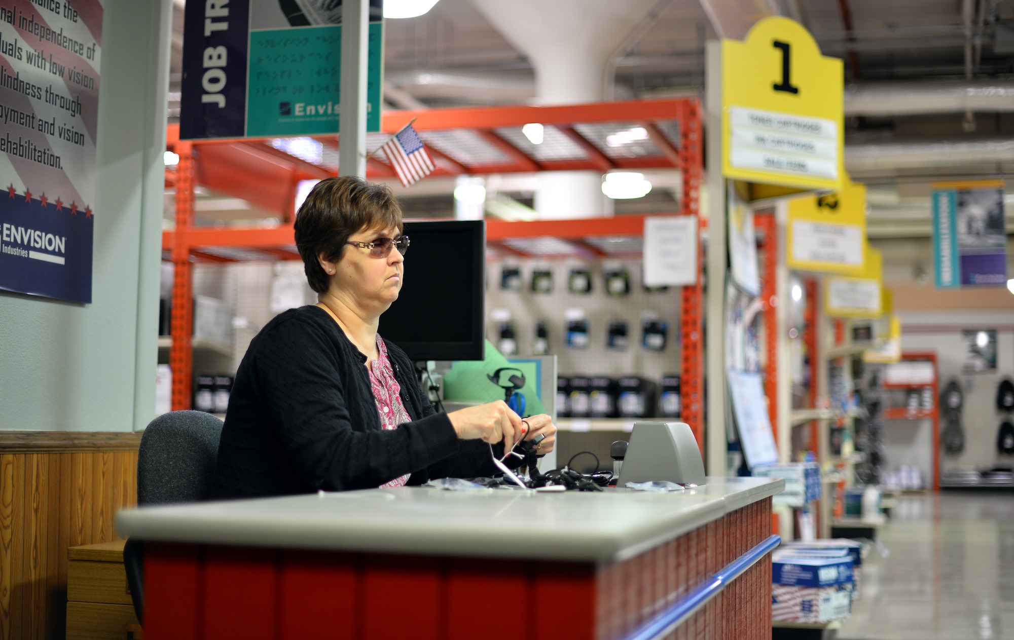 Deb Iwanksi tags merchandise Nov. 9, 2015 at the Envision Xpress store, Offutt Air Force Base, Neb. Iwasnki has been working for the store for eight months. (U.S Air Force photo by Josh Plueger)