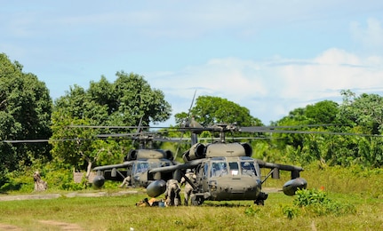 Two U.S. Army UH-60 Blackhawks assigned to the 1-228th Aviation Regiment take on Honduran soldiers, Nov. 5, 2015, in the Gracias a Dios department (state) of Honduras, during an ongoing partnership between the U.S. and Honduras to aid the Honduran military’s freedom of movement in the area. Over 300 Honduran soldiers were rotated to and from various forward operating locations to help prevent the trafficking of people and drugs in the area. (U.S. Air Force photo by Capt. Christopher J. Mesnard/Released)