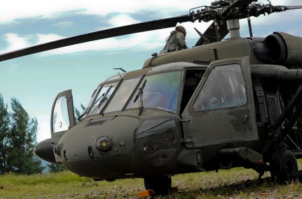 A 1-228th Aviation Regiment UH-60 Blackhawk pilot inspects his aircraft prior to a mission Nov. 5, 2015, in the Gracias a Dios department (state) of Honduras during the Operation CARAVANA XIII Honduran troop movement. In total, the 1-228th assisted the Hondurans in moving more than 300 personnel in support of the operation, designed to counter trans-national organized crime in the Central American area of operations. (U.S. Air Force photo by Capt. Christopher J. Mesnard/Released)