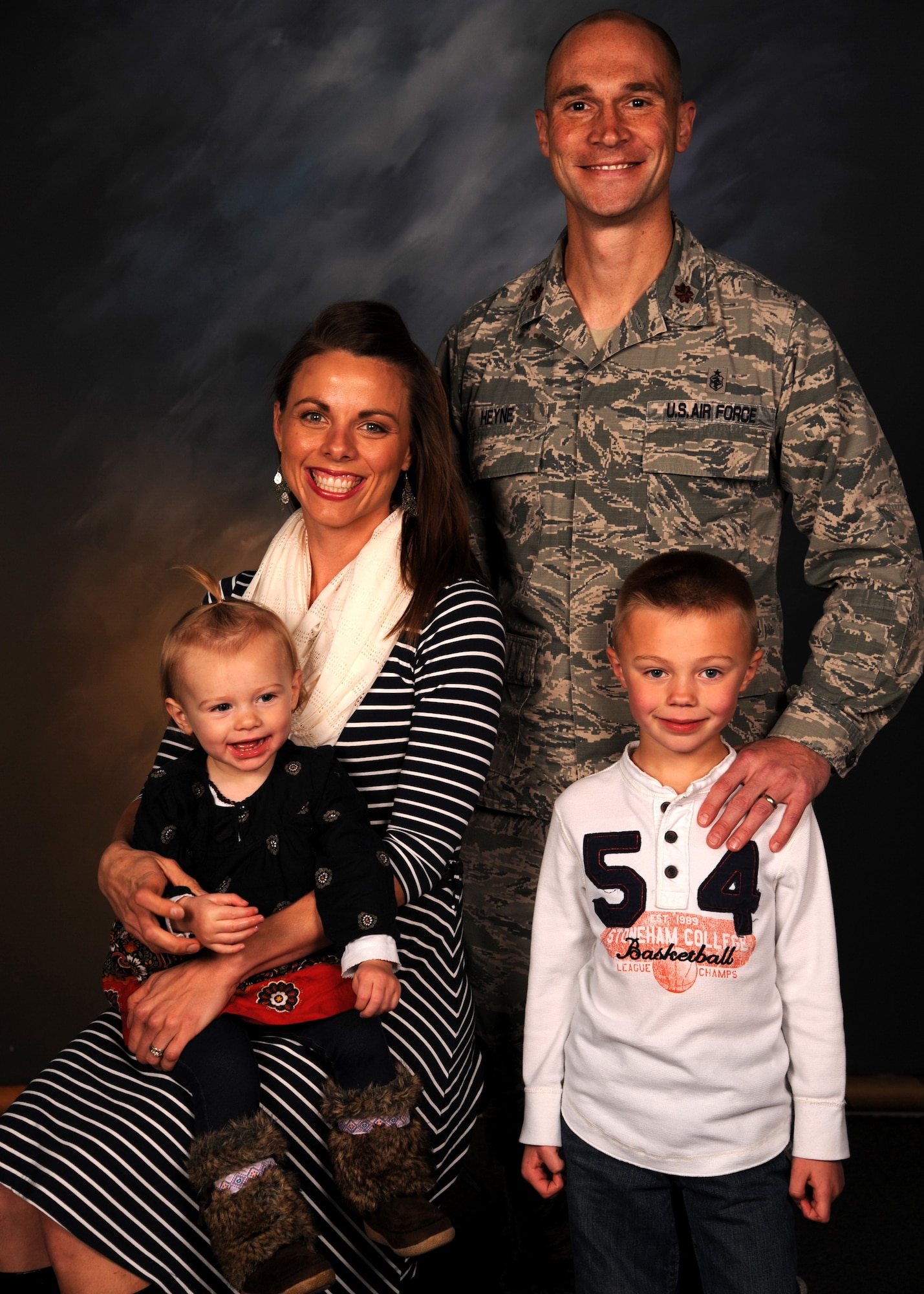 Maj. Corby Heyne, his wife Kristin and children, Kaison and Kinley, have been stationed at Grand Forks Air Force Base, North Dakota, for more than a year. Major Heyne is the 319th Medical Support Squadron medical readiness and logistics flight commander. They have experienced many of the challenges associated with being a military family, but Kristin and her children have supported Major Heyne from behind the scenes to ensure that he can support the Air Force mission. (U.S. Air Force photo by Airman 1st Class Ryan Sparks/Released)