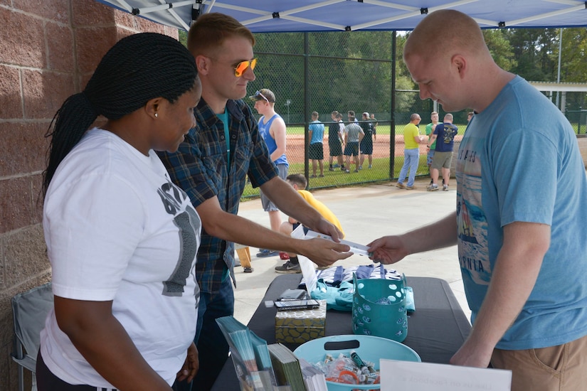 From left to right, Ebony Sharpe and Ben Armstrong, Sexual Assault Prevention and Response (SAPR) Victim Advocates assigned to Joint Base Charleston - Weapons Station share information regarding SAPR programs and services during a kickball tournament Nov. 7, 2015. The event was hosted by the Navy’s SAPR team. (U.S. Navy photo by Mass Communication 3rd Class John Haynes/Released)