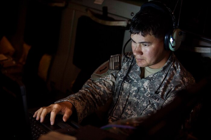 Sergeant Jonathan Bennett, assigned to the 50th Signal Battalion, checks his communications equipment during pre-flight checks, Nov. 3, 2015, during exercise Ultimate Reach 16-1. The exercise is an annual U.S. Transportation Command sponsored, live-fly exercise designed to test the ability of 18th Air Force to plan and conduct strategic airdrop missions with the 82nd Airborne Division. Four C-17 Globemaster IIIs from the 437th Airlift Squadron out of Joint Base Charleston, S.C., participated in a seven-ship formation to help airdrop more than 500 U.S. Army and Spanish military jumpers in Zaragoza, Spain. (U.S. Air Force photo/Senior Airman Jared Trimarchi)
