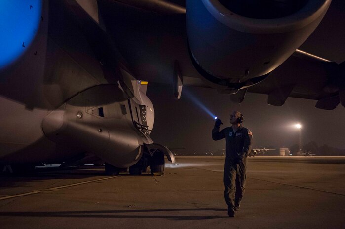 Staff Sgt. Mitch Utter, from the 437th Airlift Wing, inspects the side of a C-17 Globemaster III before take-off at Zaragoza, Spain, Nov. 7, 2015, during exercise Ultimate Reach 16-1. The exercise is an annual U.S. Transportation Command sponsored, live-fly exercise designed to test the ability of 18th Air Force to plan and conduct strategic airdrop missions with the 82nd Airborne Division. Four C-17 Globemaster IIIs from the 437th Airlift Squadron out of Joint Base Charleston, S.C., participated in a seven-ship formation to airdrop more than 500 U.S. Army and Spanish military jumpers. (U.S. Air Force photo/Senior Airman Jared Trimarchi)