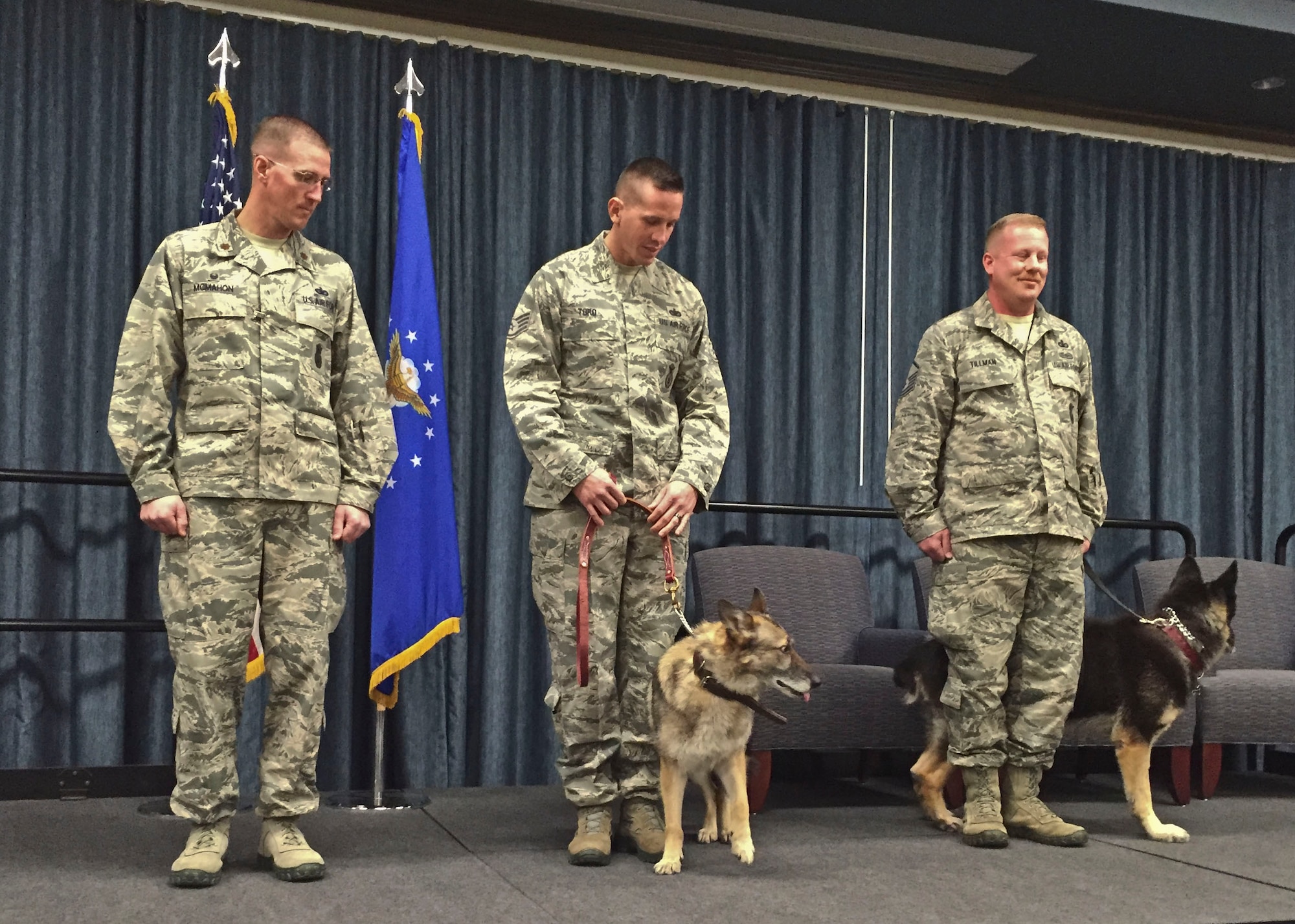 Maj. Kevin McMahon, 92nd Security Forces Squadron commander, Staff Sgt. Jonathan Toro, 92nd SFS military working dog handler, and Master Sgt. Brandon Tillman, 92nd SFS MWD handler, stand with MWD Helena (left) and MWD Bonno (right), during a MWD retirement ceremony Nov. 12, 2015, at Fairchild Air Force Base, Wash. Both of the MWD’s have served the 92nd Security Forces Squadron from 2007 to 2015, each specializing in different fields. (U.S. Air Force Photo/Colonel Matthew Fritz)