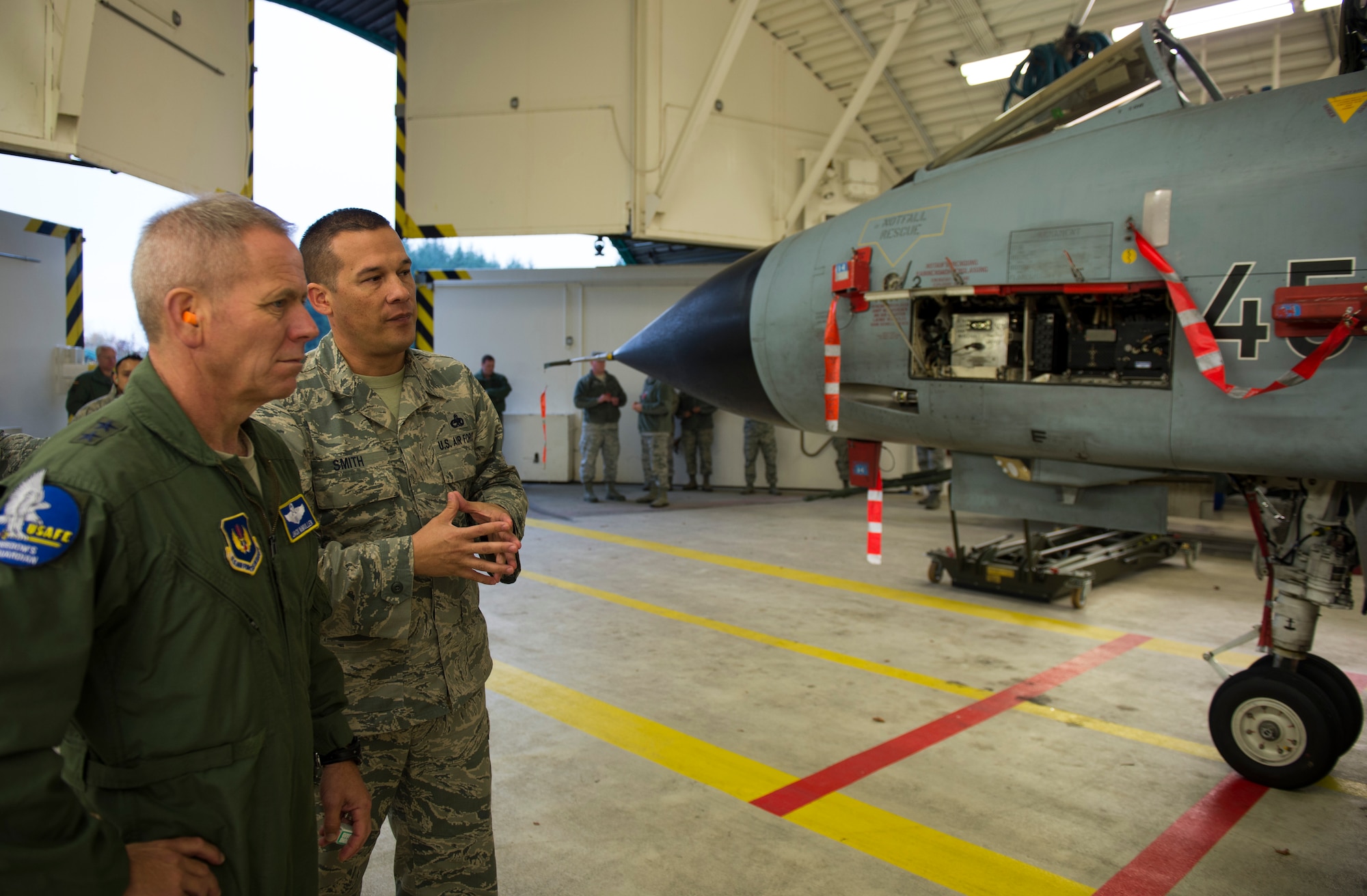U.S. Air Force Master Sgt. Nathen Smith, 702nd Munitions Support Squadron senior load monitor, briefs U.S. Air Force Maj. Gen. John McMullen, U.S. Air Forces in Europe and Air Forces Africa Strategic Deterrence Integration director of operations, on how munitions are loaded onto a German air force PA-200 Tornado multirole combat aircraft during a tour of 702nd MUNSS at Buechel Air Base, Germany, Nov. 10, 2015. The 702nd MUNSS is a geographically separated unit responsible for receipt, storage, maintenance and control of US war reserve munitions in support of the German air force 33rd Fighter-Bomber Wing. (U.S. Air Force photo by Staff Sgt. Christopher Ruano/Released)