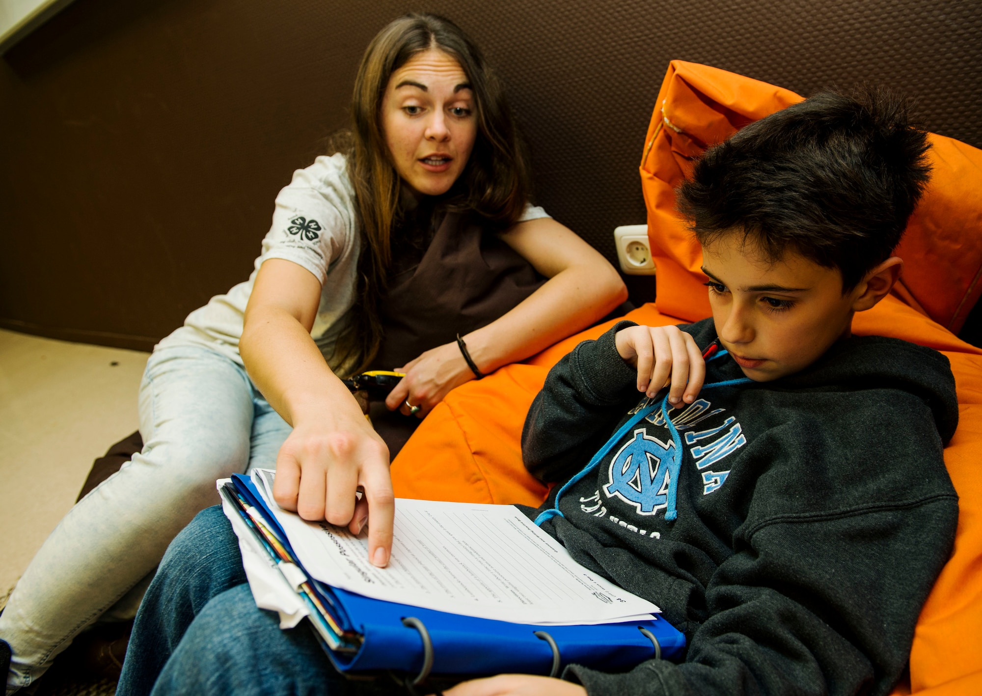 Brianna Johnston, 52nd Force Support Squadron School Age Care Program Power Hour staff member, left, assists Jackson Sansosti, right, with homework during the Power Hour in the School Age Program building at Spangdahlem Air Base, Germany, Nov. 10, 2015. The SACP staff guides students from the ages of eight to 12 on homework and other school-related subjects. (U.S. Air Force photo by Airman 1st Class Timothy Kim/Released)