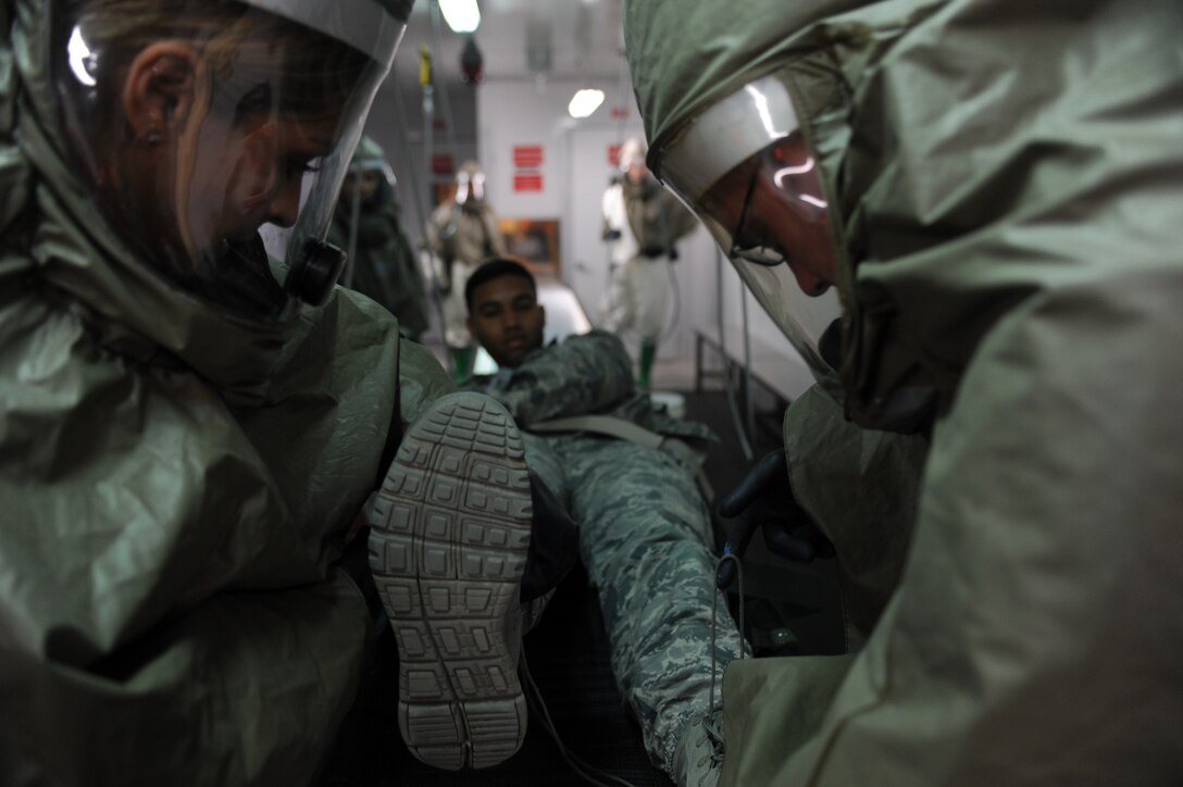 Tech. Sgt. Dilcia Kammermeyer, 39th Medical Operations Squadron Preventive Dentistry non-commissioned officer in charge, and Staff Sgt. Aaron Youngblood, 39th MDOS NCOIC of physical therapy, begin to prepare Airman 1st Class Xavier Jones, MDOS public health technician, for decontamination during an exercise Oct. 28, 2015, at Incirlik Air Base, Turkey. 39th Medical Group personnel are trained to decontaminate as well as administer medical treatment in the event of an emergency that requires evaluating, stabilizing, treating and transporting casualties as well as those who get exposed or potentially exposed to contaminants. (U.S. Air Force photo by Airman 1st Class Daniel Lile/Released)