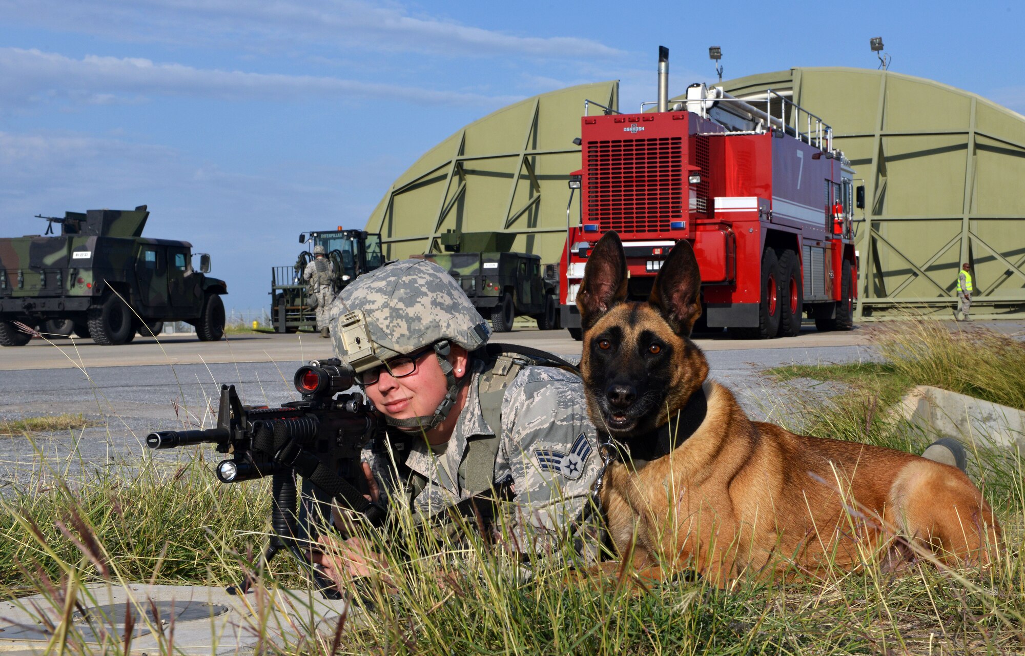 A member of the 39th Security Forces Squadron and her assigned military working dog hold a defensive position during a wing exercise Nov. 5, 2015, at Incirlik Air Base, Turkey. Week-long exercises are held annually at Incirlik AB to test the response time and capabilities of members of the 39th Air Base Wing. (U.S. Air Force photo by Staff Sgt. Michael Battles/Released)