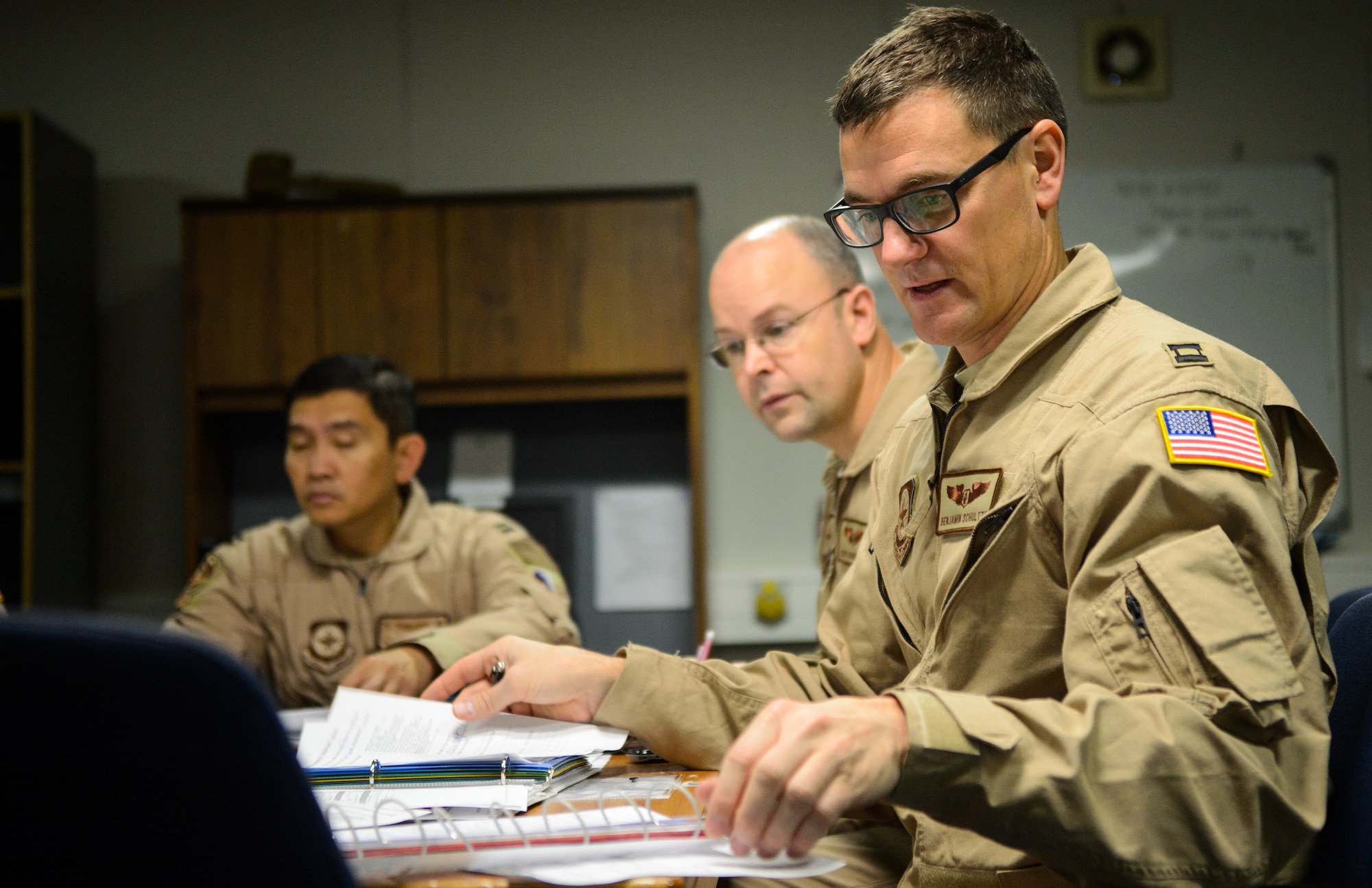 Capt. Benjamin Schultze, right, 10th Expeditionary Aeromedical Evacuation Flight nurse, discusses the flight plan with the medical crew Nov. 10, 2015, at Ramstein Air Base, Germany. The Airmen of the 10th EAEF conducted a flight to evacuate service members in need of medical attention from deployed locations. (U.S. Air Force photo/Staff Sgt. Armando A. Schwier-Morales)