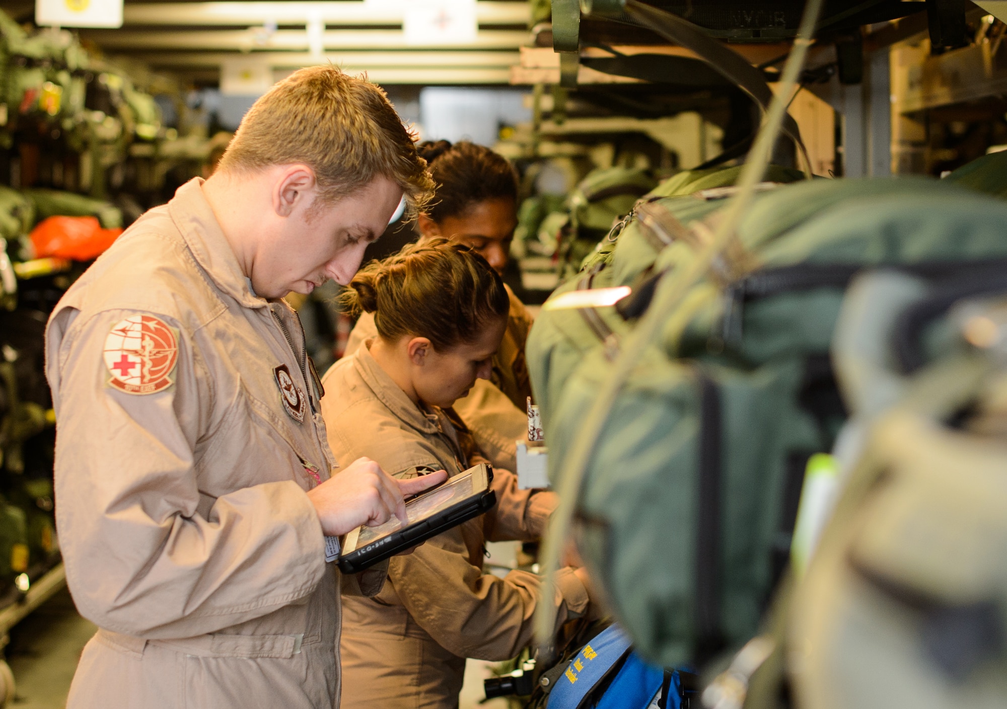 Senior Airmen Ryan Rieth, left, Beverly Spencer, center, and Master Sgt. Natalia Stockhausen, all 10th Expeditionary Aeromedical Evacuation Flight technicians, inventory medical equipment Nov. 10, 2015, at Ramstein Air Base, Germany. The three technicians helped treat and care for patients midair as they are returned from deployed locations for higher level medical treatment. (U.S. Air Force photo/Staff Sgt. Armando A. Schwier-Morales)
